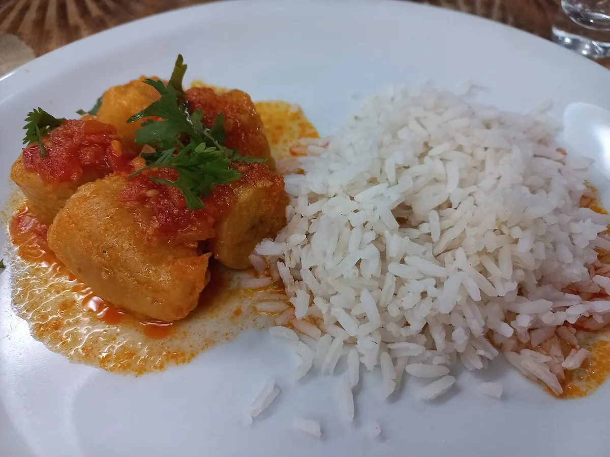 Moqueca de banana-da-terra com molho de tomate e coentro, servida com arroz branco